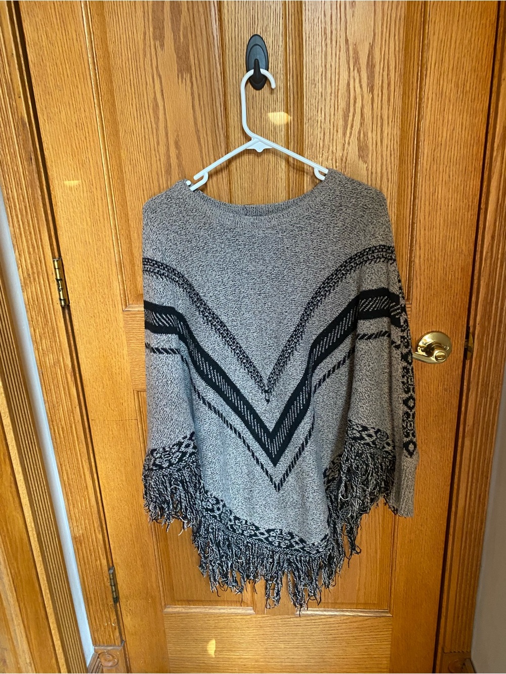 Fringed Chevron Knit Poncho Sweater - Gray/Black
Anna Morgan
One size